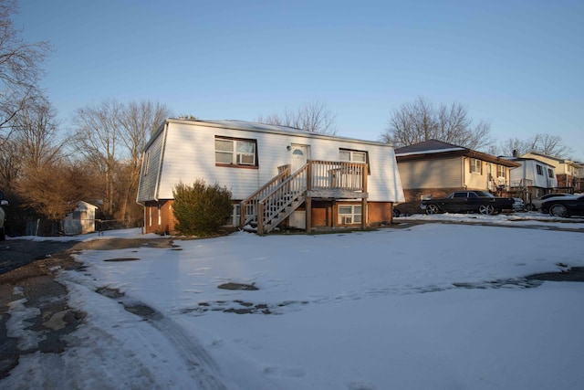 view of snow covered rear of property