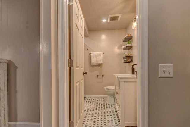 bathroom with toilet and vanity