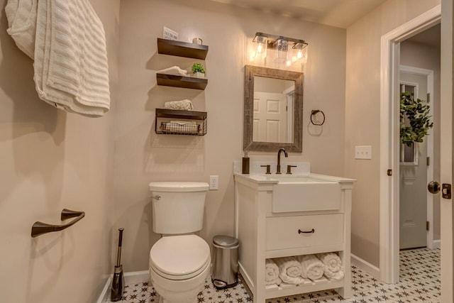 bathroom featuring toilet and vanity