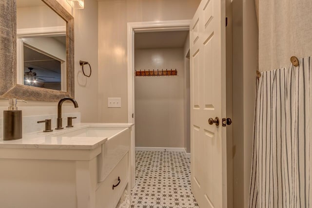 bathroom with ceiling fan and vanity