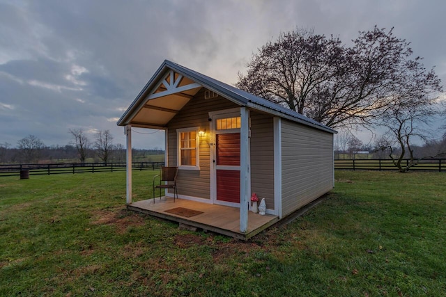 view of outbuilding with a rural view and a yard