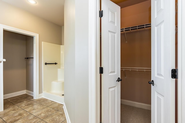 bathroom featuring a shower and tile patterned flooring