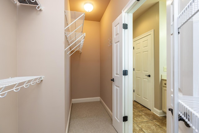 spacious closet featuring light tile patterned floors