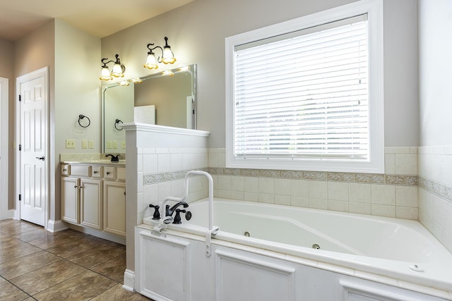 bathroom with vanity, tile patterned floors, and a tub to relax in