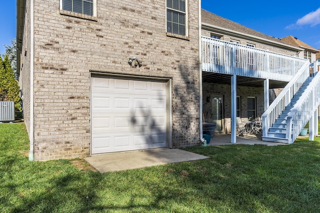 back of house featuring a garage, a patio area, a lawn, and central air condition unit