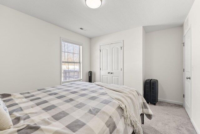 bedroom with carpet flooring and a nursery area