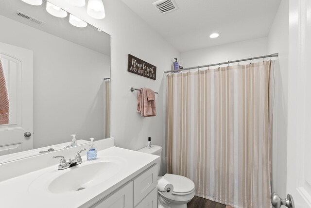 full bathroom featuring toilet, vanity, and shower / bath combo