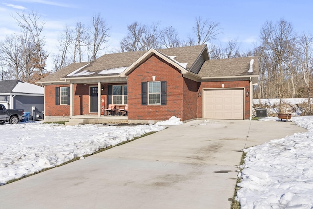 ranch-style house featuring a porch, central AC, and a garage