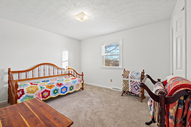 carpeted bedroom featuring a textured ceiling