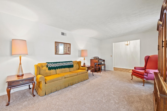 living room featuring light colored carpet and a textured ceiling