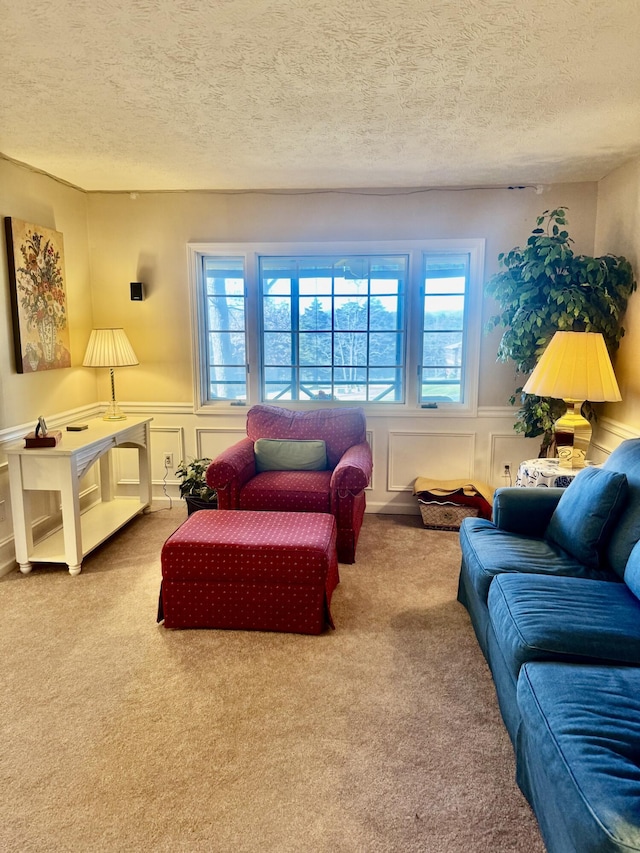 living room featuring a textured ceiling and carpet floors