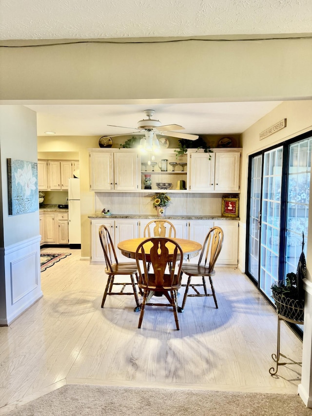 dining area featuring ceiling fan and light hardwood / wood-style flooring