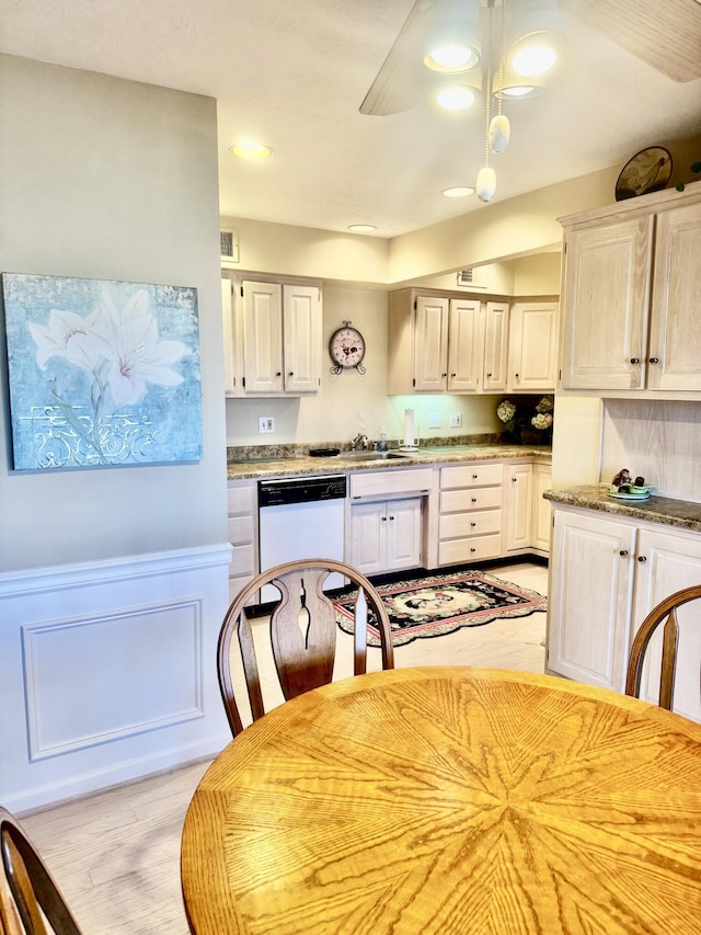 kitchen featuring light wood-type flooring, sink, and white dishwasher