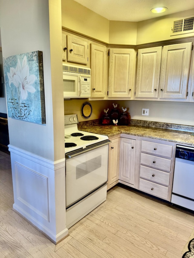 kitchen featuring light hardwood / wood-style floors and white appliances