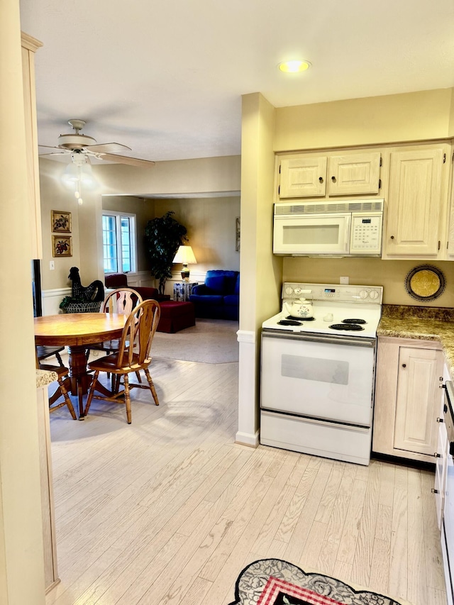 kitchen with white appliances, light hardwood / wood-style floors, ceiling fan, light stone counters, and cream cabinetry