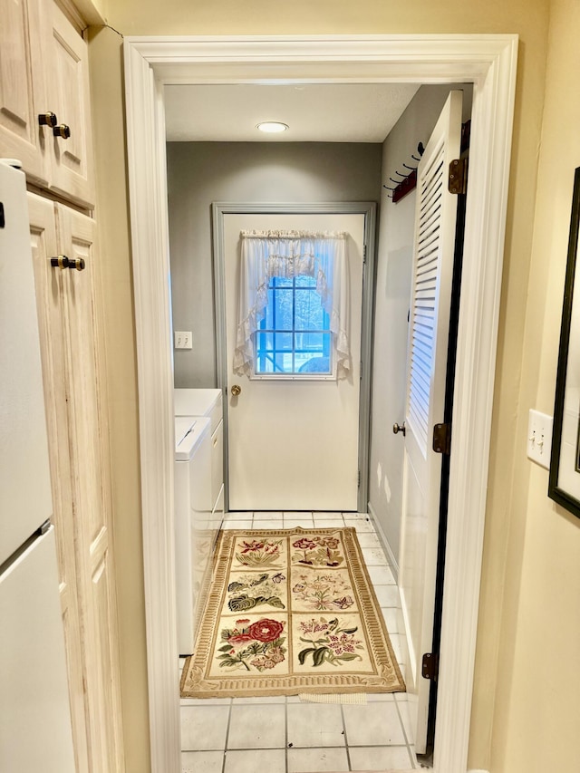 doorway with washer and dryer and light tile patterned flooring