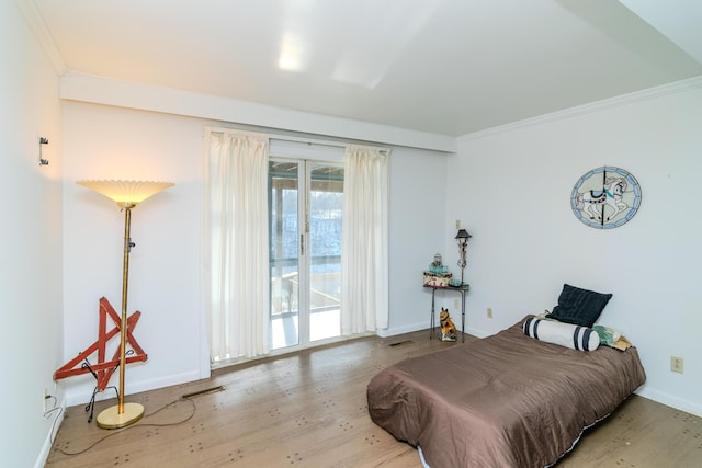 bedroom with crown molding, hardwood / wood-style flooring, and access to outside