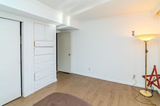 interior space with crown molding and light wood-type flooring