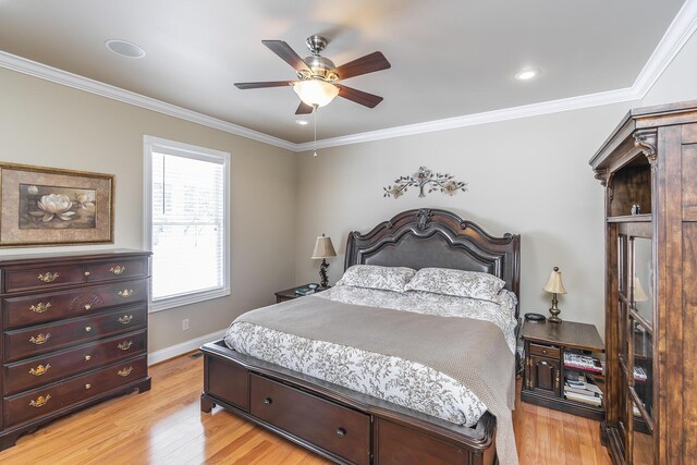 bedroom with crown molding, ceiling fan, and light hardwood / wood-style floors