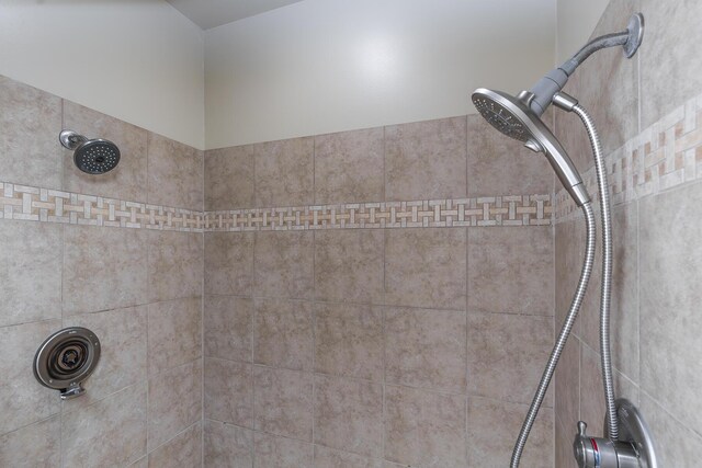 interior details with a tile shower