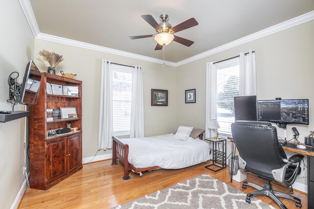 bedroom featuring multiple windows, ornamental molding, and light hardwood / wood-style flooring