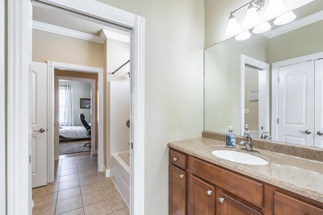 bathroom with tile patterned flooring, ornamental molding, vanity, and shower / bathtub combination