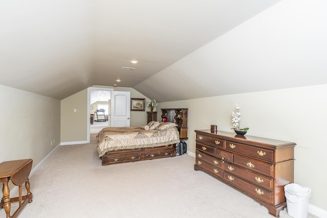 bedroom featuring light colored carpet and vaulted ceiling