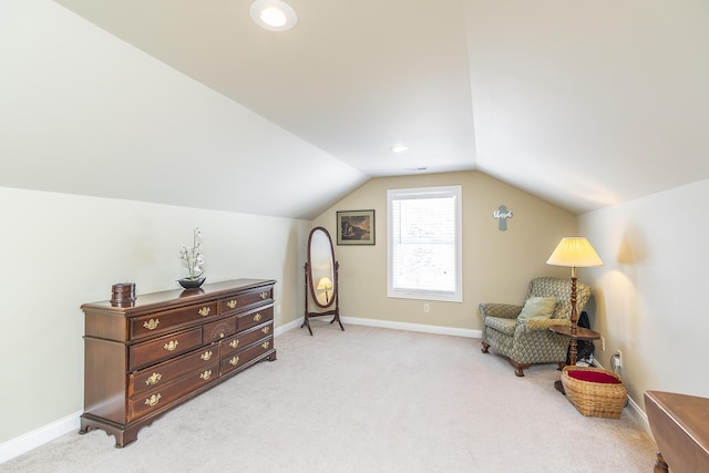 sitting room featuring lofted ceiling and light carpet