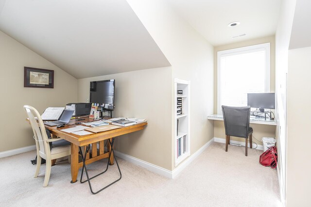 home office featuring light carpet and lofted ceiling