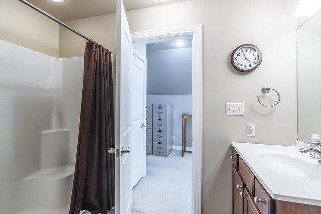 bathroom featuring vanity and curtained shower