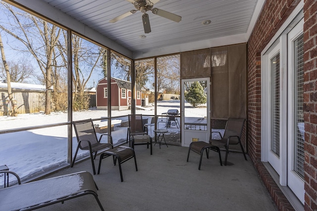 unfurnished sunroom with ceiling fan