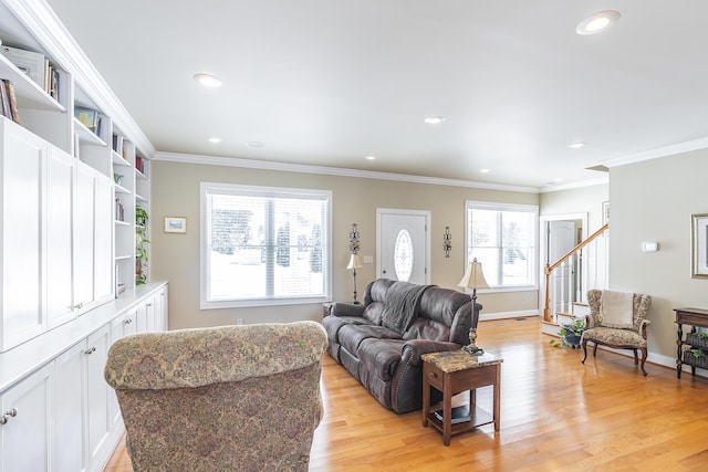 living room featuring crown molding and light hardwood / wood-style flooring