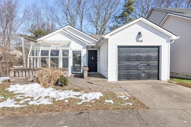 ranch-style home with a garage and a sunroom