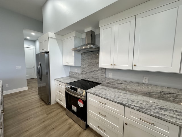 kitchen featuring white cabinetry, appliances with stainless steel finishes, tasteful backsplash, light stone countertops, and wall chimney exhaust hood