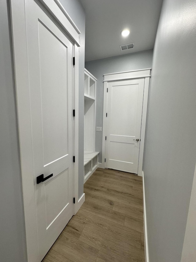 mudroom with light hardwood / wood-style floors