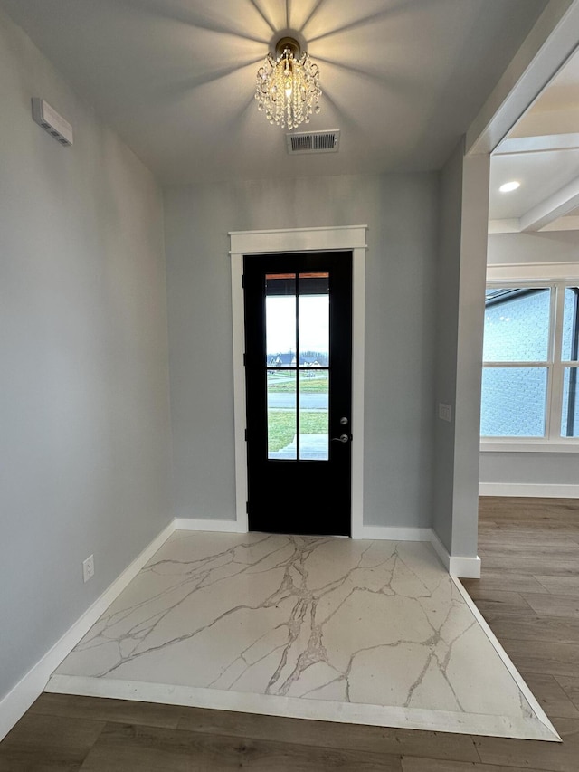 entryway with a chandelier