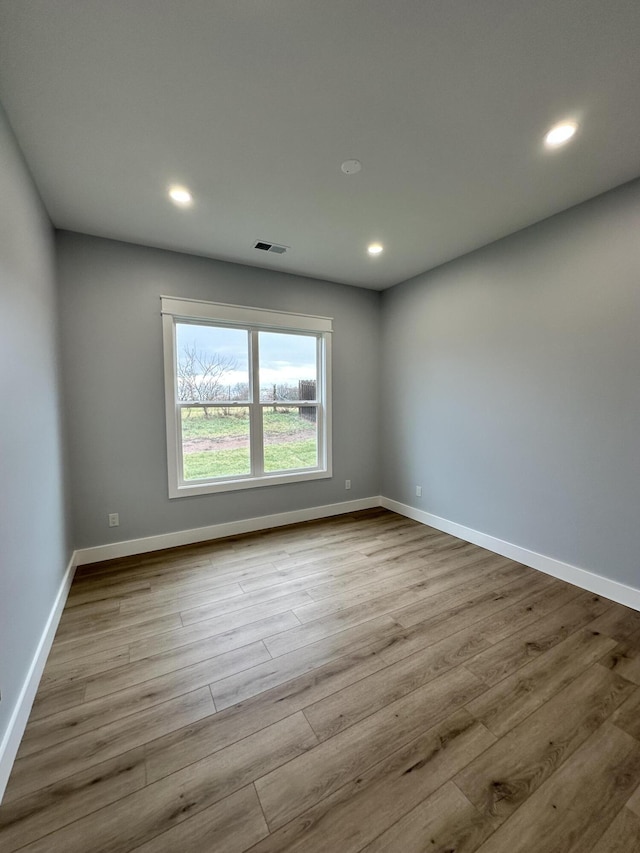 unfurnished room with light hardwood / wood-style floors