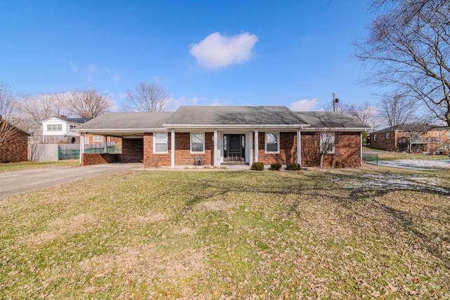 ranch-style home featuring a front yard and a carport