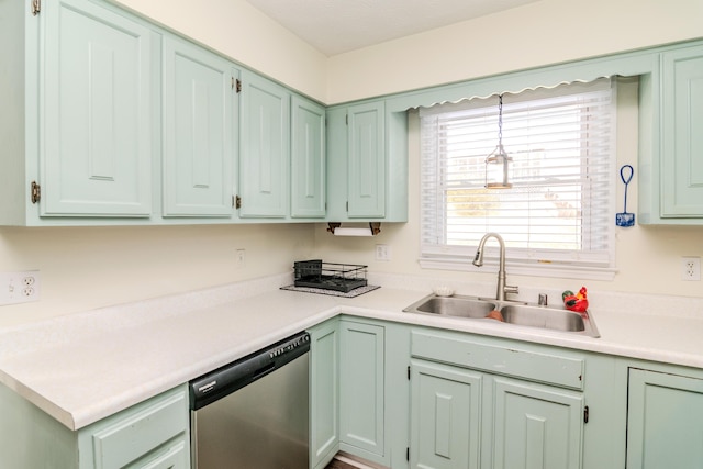 kitchen featuring pendant lighting, sink, green cabinetry, and dishwasher