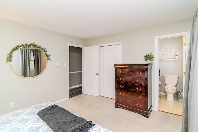 carpeted bedroom featuring connected bathroom and a closet