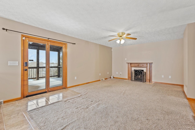 unfurnished living room with ceiling fan, light colored carpet, and a textured ceiling