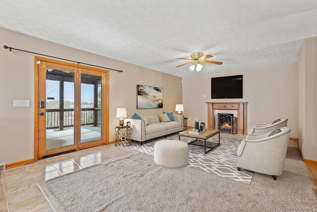 unfurnished living room with sink, light tile patterned floors, ceiling fan with notable chandelier, and a textured ceiling