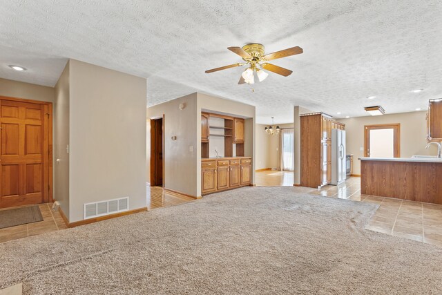 dining room with a notable chandelier, light hardwood / wood-style flooring, and a textured ceiling