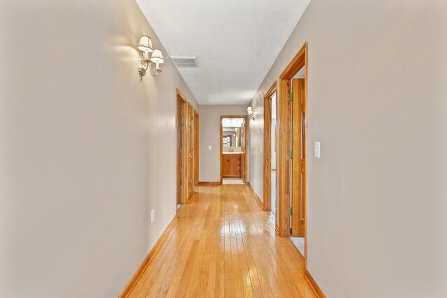 carpeted empty room featuring track lighting and a textured ceiling