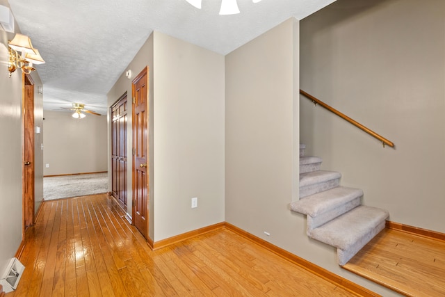 interior space with hardwood / wood-style flooring, ceiling fan, and a textured ceiling