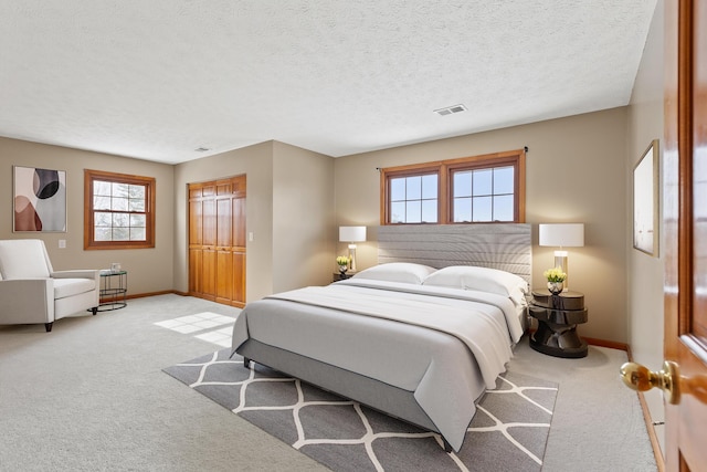 bedroom with carpet, multiple windows, and visible vents