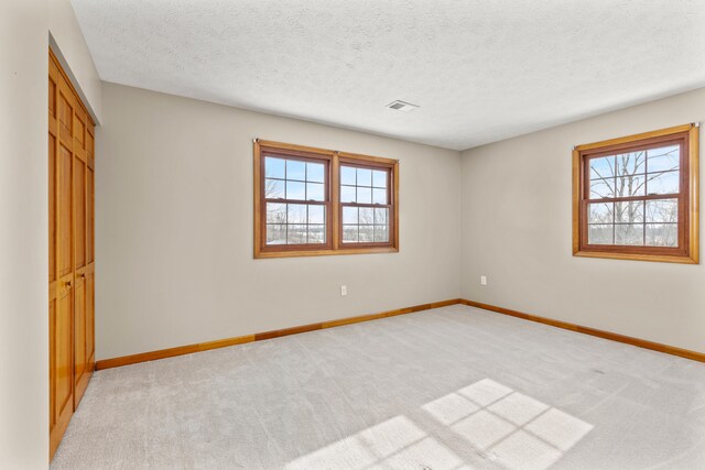 carpeted home theater room with a textured ceiling and billiards