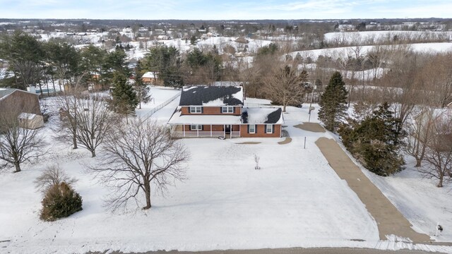 snow covered property featuring a porch