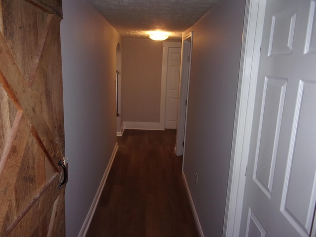 hallway with a textured ceiling