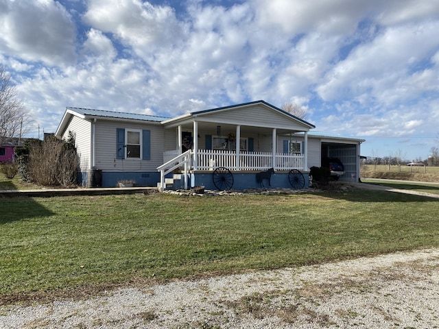 view of front of property featuring a front yard, a garage, and a porch